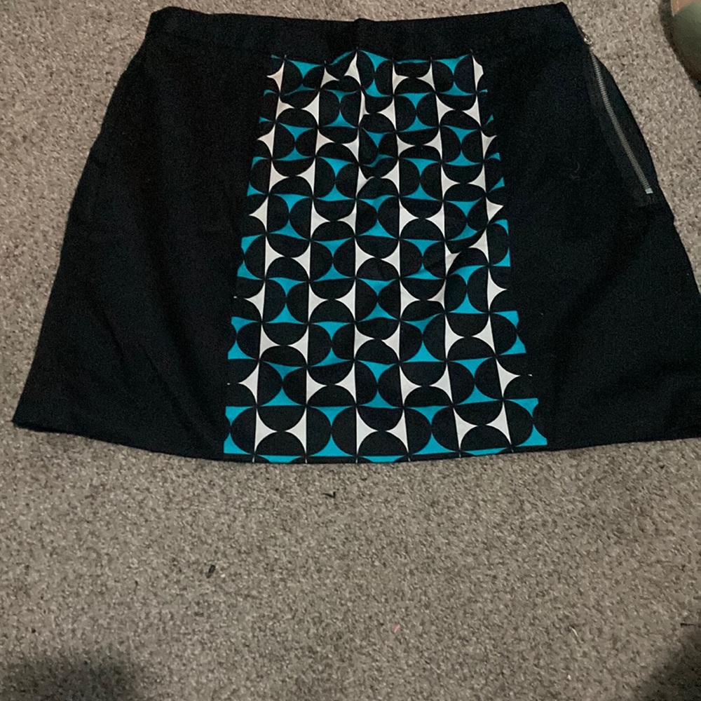 Black mini skirt with printed panels on front and back.